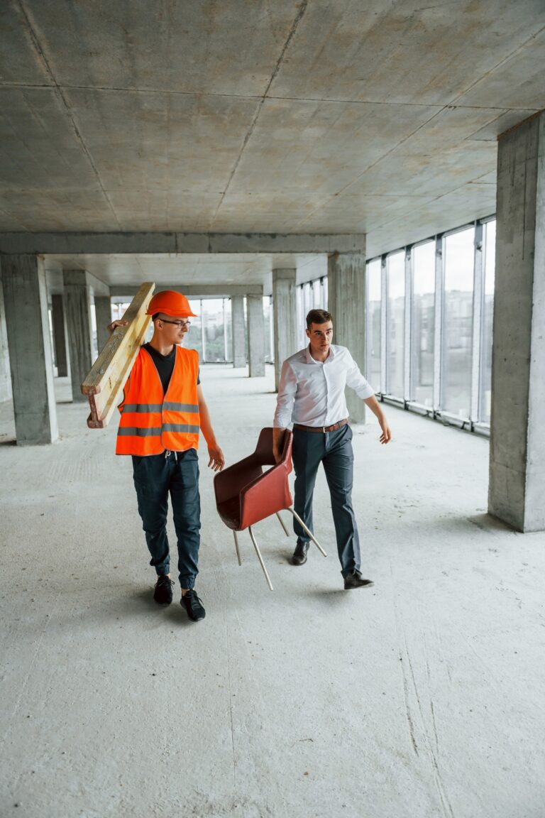 vve schoonmaak amsterdam 2 Man in suit and handyman in orange protective wear is working on construction